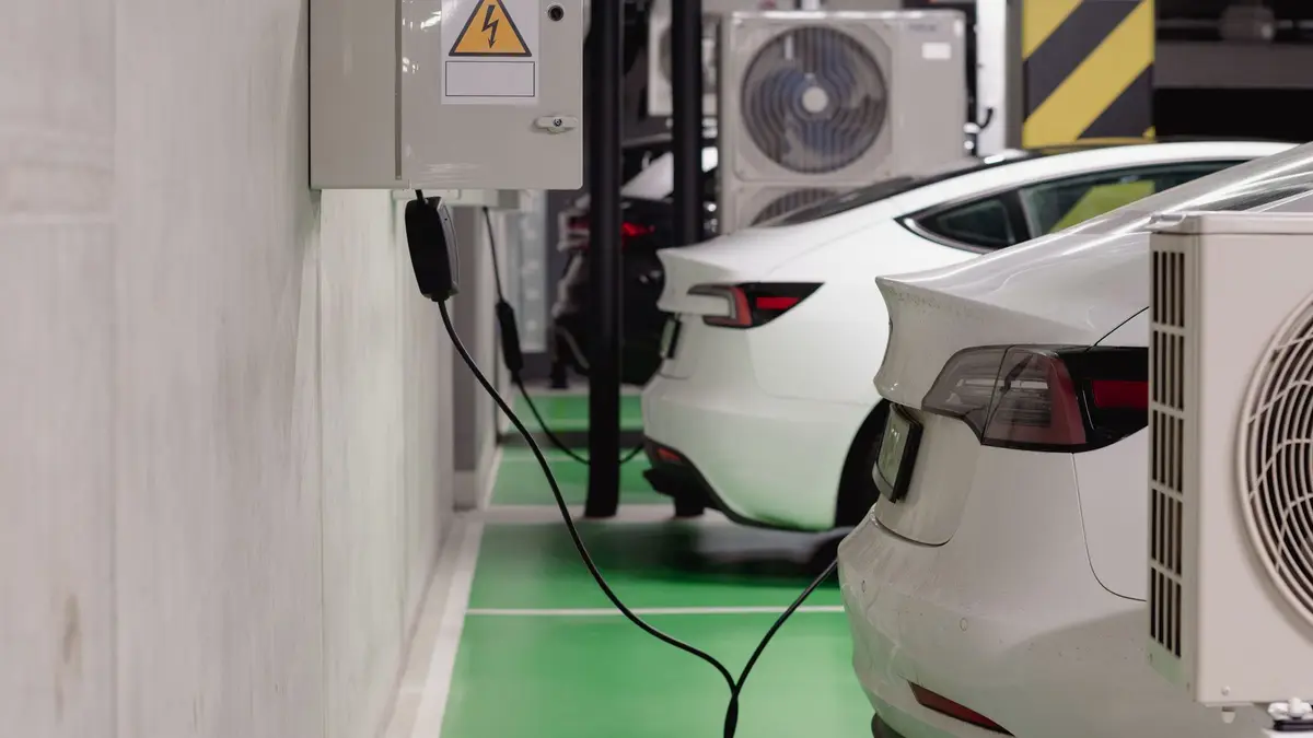 Electrician installing a home EV charger on a garage wall in Sydney